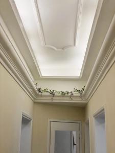 a coffered ceiling in a hallway with flowers at Ad Agio Apartments in Pisa