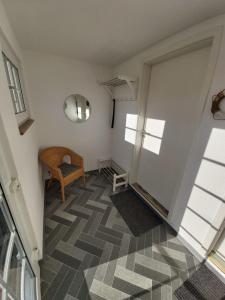 a room with a hallway with a chair and a window at Ferienhaus Usedom Familie Stopp Haus 23 in Lütow