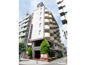 a large white building on the side of a street at Hotel Tetora Tsurumi - Vacation STAY 37288v in Yokohama