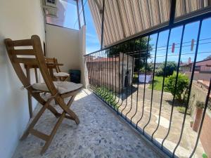 a rocking chair sitting on a balcony looking out at the view at Ad Agio Apartments in Pisa