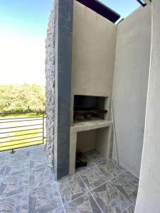 a fireplace in a room with a stone wall at Morningside41 in Ongwediva