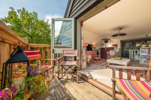 a deck with chairs and tables and a house at Vibrant rural hideaway - Aspen Loft in Sudbury
