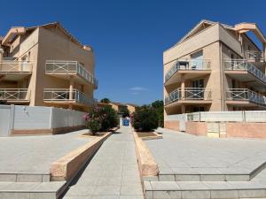 a building with balconies on the side of it at Maison T3 avec petit jardin in Valras-Plage