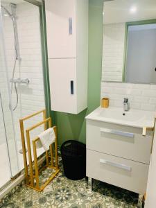 a bathroom with a sink and a shower at Marie Lou à la ville in Angoulême
