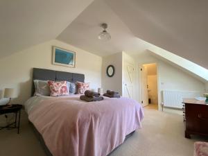 a bedroom with a bed with a teddy bear on it at Private detached cottage sleeps 4 in Crieff