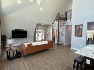 a living room with a couch and a tv at Lakefront Keowee Luxury Cottages 127 in Seneca