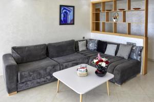 a living room with a couch and a table at Baya house Tamraght seaview in Tamraght Ouzdar