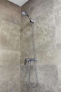 a shower with a shower head in a bathroom at Baya house Tamraght seaview in Tamraght Ouzdar