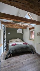 a bedroom with a large bed in a attic at Tu casita au centre-ville de Rouffach in Rouffach