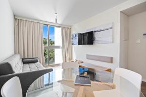 a living room with a couch and a table at Own Montevideo in Montevideo