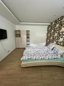 a bedroom with a bed and a television in it at Prie Baseino Kretingos g 40 in Palanga