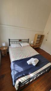 a bedroom with a bed with a towel on it at Urban Rhythm in Brisbane