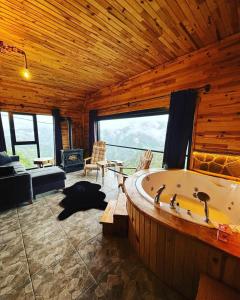 a large room with a bath tub in a cabin at sitiela bungalov kir evi in Çamlıhemşin