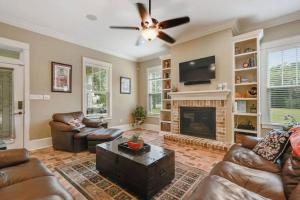 a living room with leather furniture and a fireplace at Ocean View-3 Bdrm Plus Mother-In-Law Suite - E-bikes in Gulfport