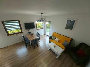 a living room with a couch and a table at Domek w ogródku in Bardo