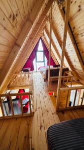 a room with bunk beds in a wooden attic at sitiela bungalov kir evi in Çamlıhemşin +57 photos