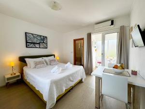 a bedroom with a bed and a table with a bowl of fruit on it at Hvar Sunny hill in Hvar