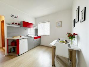 a kitchen with a table and a white counter top at Hvar Sunny hill in Hvar +26 photos