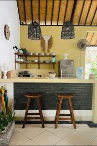 a kitchen with a counter with two stools at Luka Villas - Luxury 2 Bedroom Private Pool Villa in Seminyak