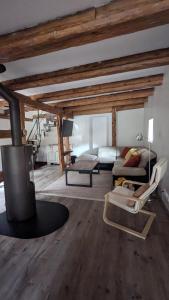 a living room with a fireplace and a couch at Tu casita au centre-ville de Rouffach in Rouffach