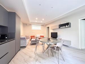 a kitchen and living room with a table and chairs at Homeby, Modern Loft Pisa in Pisa +2 photos