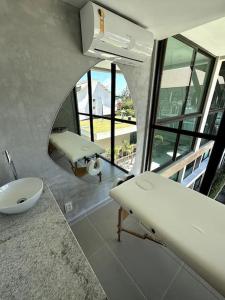 a bathroom with a sink and a mirror at SUNNY HALL Porto de galinhas in Porto De Galinhas