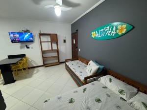 TV a/nebo společenská místnost v ubytování Apartamentos e Flats da Taty Praia das Toninhas - Ubatuba + 14 fotografií