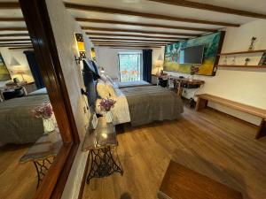 a hotel room with two beds and a television at ARQUEOLOGO EXCLUSIVE SELECTION - Casa Peralta in Cusco