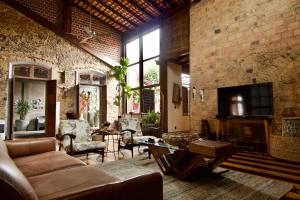 a living room with a couch and chairs and a tv at Cas'Amazonia Brasil in Belém