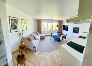 a living room with a couch and a table at Liiva Paasukese Apartment in Liiva