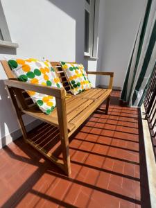 a wooden bench sitting on top of a floor at Casa Margherita (Alba) in Alba