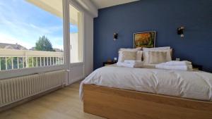 安锡Lac Plage et Ville 95 m2 a 100m du lac, 3 chambres, parking的一间带大床和大窗户的卧室