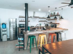 a kitchen with a counter with colorful bar stools at Sunset Hour in San Juan