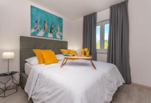 a bedroom with a bed with a table on it at House with pool Ledenko in Biograd na Moru
