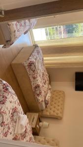 a small room with two beds and a window at Guest House Bracaj in Çorovodë