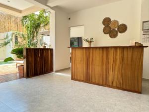 a lobby with a wooden reception desk and a window at Casa Ita Surf - Adults Only in Puerto Escondido