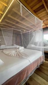 Postel nebo postele na pokoji v ubytování Hostal MOCAMBO BEACH