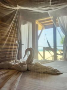 Postel nebo postele na pokoji v ubytování Hostal MOCAMBO BEACH