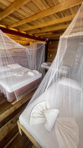 Postel nebo postele na pokoji v ubytování Hostal MOCAMBO BEACH