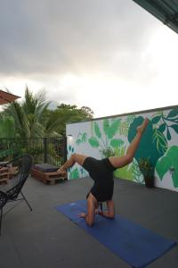 a woman doing a handstand on a yoga mat at Argdivan Hostel in Fortuna