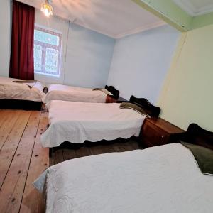 A bed or beds in a room at Chvibiani Guesthouse & Bar