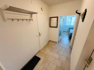 a hallway with a door and a tiled floor at GAMSBLICK - Traumhaftes Bergpanorama, Parkplatz & Pool in Bad Aussee