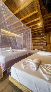 Postel nebo postele na pokoji v ubytování Hostal MOCAMBO BEACH