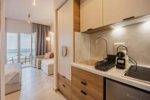 a kitchen with a sink and a counter top at Anna Beach Suites in Limenaria