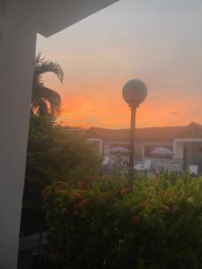 a sunset from the patio of a resort with a street light at Hotel Villa Ricaurte in Girardot