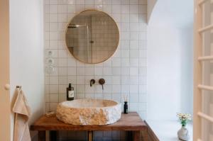a bathroom with a stone sink and a mirror at Chalupa Čížovka in Kněžmost