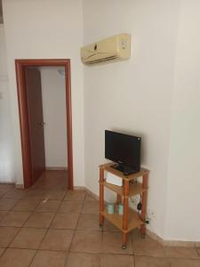a room with a television and a air conditioner on the wall at Casa del Papavero in Piombino
