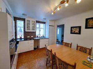 a kitchen with a wooden table and a dining room at Spacious Apartment -Top Location in Akureyri