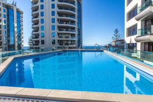 a large swimming pool in the middle of a building at Eleven_at_Mauao in Mount Maunganui