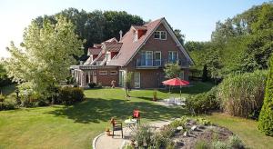 a large house with a yard with at Hotel Waldblick Deppe in Lippstadt